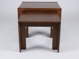 a pair of small tables on a white surface with a white background