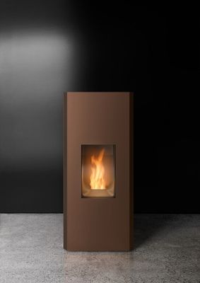 a brown fireplace sitting on top of a cement floor next to a black wall