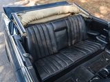 an image of a black car with leather seats in the back of it