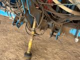 an image of a tractor with a hose attached to it ' s back