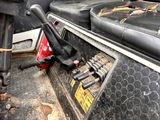 a close up of a gas pump in the back of a truck