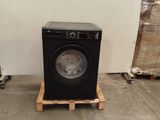 a washing machine sitting on a pallet in a warehouse