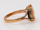 a close up of a gold ring with a stone in it