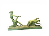 statue of a woman with a dog and a man on a boat