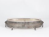 a silver plate with handles and handles on a stand