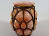 a small vase with a flower design on it