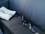 a seat in the back of a car with a towel on it