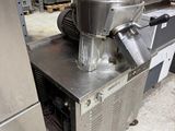 a machine that is sitting on the floor in a warehouse