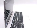 a white laptop with a black keyboard on a white surface