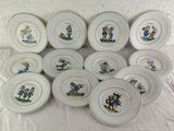 many plates with pictures of people on them on a table