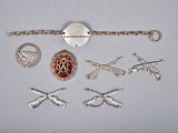 several different types of silver and gold jewelry on a white surface