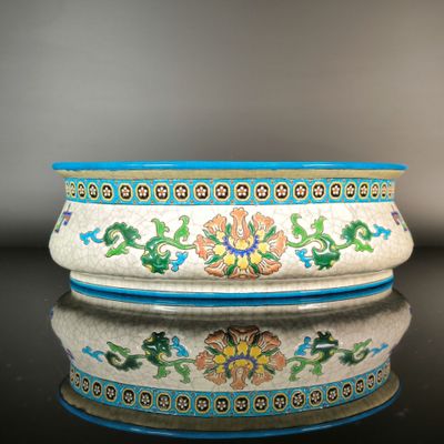 a white bowl with colorful designs on it on a table
