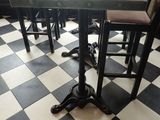 tables and chairs in a restaurant with black and white checkered floor