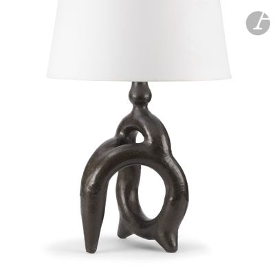 a close up of a lamp on a table with a white shade