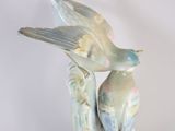 two birds that are sitting on top of each other
