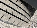 a close up of a car tire on the ground