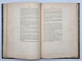 an open book on a white surface with a black border