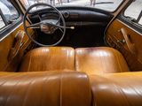 dashboard of an old car with leather seats and a steering wheel