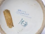 a close up of a white bowl with a brown stripe on it