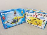 two boxes of playmobil toys on a table