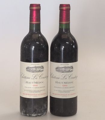 two bottles of wine sitting next to each other on a table