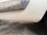 a close up of a car ' s bumper with rust on it