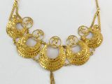the necklace is made of gold metal and has a tassel on it