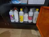 bottles of cleaning products are sitting on a shelf in a bathroom