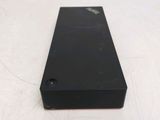 the back of a black cell phone sitting on top of a white table