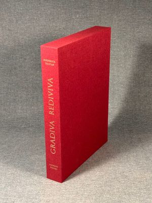 a red book sitting on top of a gray surface