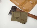 an old axe with a pouch next to it on a table