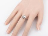 a close up of a person ' s hand with a ring on it