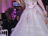 a woman that is walking down the runway with a little girl