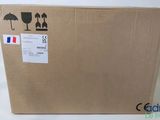 a cardboard box with a sticker on it sitting on a white surface