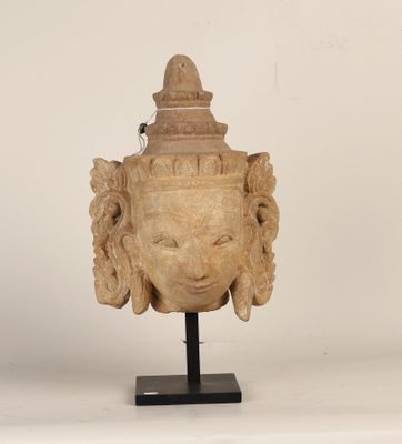 an image of a statue of a head on a black stand