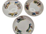 three plates with different designs on them on a white surface