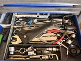 a tool box full of tools sitting on the floor