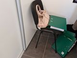 a chair and a table in a room with a bag on it