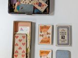 a box of playing cards, a pen, and a box of playing cards