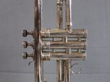 an old silver trumpet with a silver bell on a white background