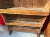 a wooden shelf with two shelves on top of it