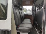 a seat in the back of a van with a window open