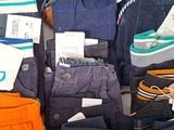 many pairs of pants that are sitting on a table