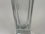 a clear glass vase sitting on a white surface