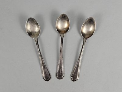 three silver spoons sitting next to each other on top of a table
