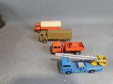 three toy trucks that are sitting on a table