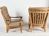 pair of mid - century danish lounge chairs with upholstered cushions