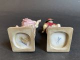 pair of porcelain figurines of a man riding a horse and a woman riding a horse
