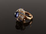 a close up of a ring on a black surface with a reflection