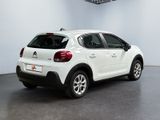 the back of a white citrole parked in a room